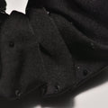 Black scrunchie on a light gray background