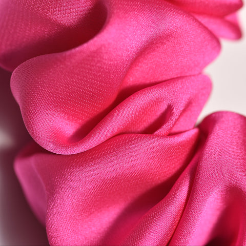 Close-up of a pink scrunchie with a blurred background